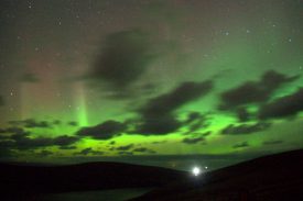 Aurora borealis over Muckle Flugga. From Saxa Vord - the bright light is the Muckle Flugga lighthouse. | Photograph copyright Mike Pennington. Originally uploaded to  https://www.geograph.org.uk/ and licensed under the Creative Commons ShareAlike 2.0 license.