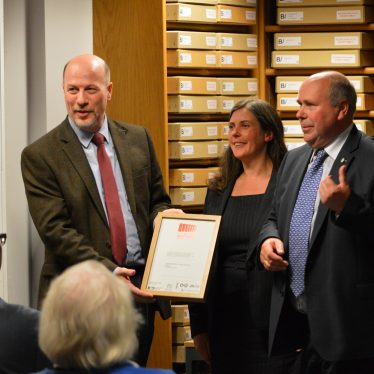 The National Archives Chief Executive & Keeper Jeff James presents the Archive Accreditation certificate to Sam Collenette of the Record Office and Councillor Jeff Clarke. | © Warwickshire County Record Office
