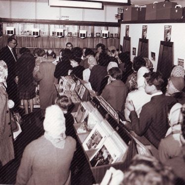 Display of gramaphone records, listening booths and a crowd of people including women in headscarves | Picture courtesy of Nuneaton Memories