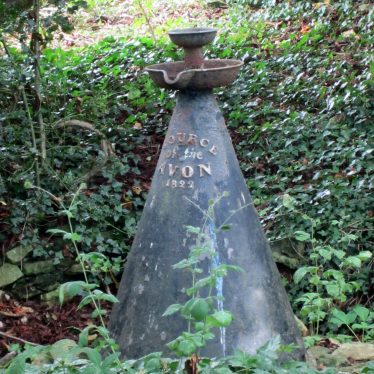 Metal cone with fountain and small basin on top. 'Source of the Avon 1822' written on it | Anne Langley