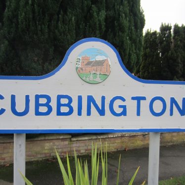 Cubbington village sign with picture of local church in pink sandstone standing in churchyard | Image courtesy of Anne Langley