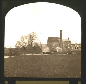 Mill buildings including tall chimney beside river | Courtesy of Warwickshire CC, Rugby Library Local Studies Collection; Warwickshire County Record Office reference PH827/5/30; photographer Rev. E. Dew