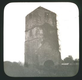 Square stone tower with ivy growing up it; windows in tower and and arched entrance | Courtesy of Warwickshire CC, Rugby Library Local Studies Collection; WCRO PH827/5/27; photographer Rev. E. Dew