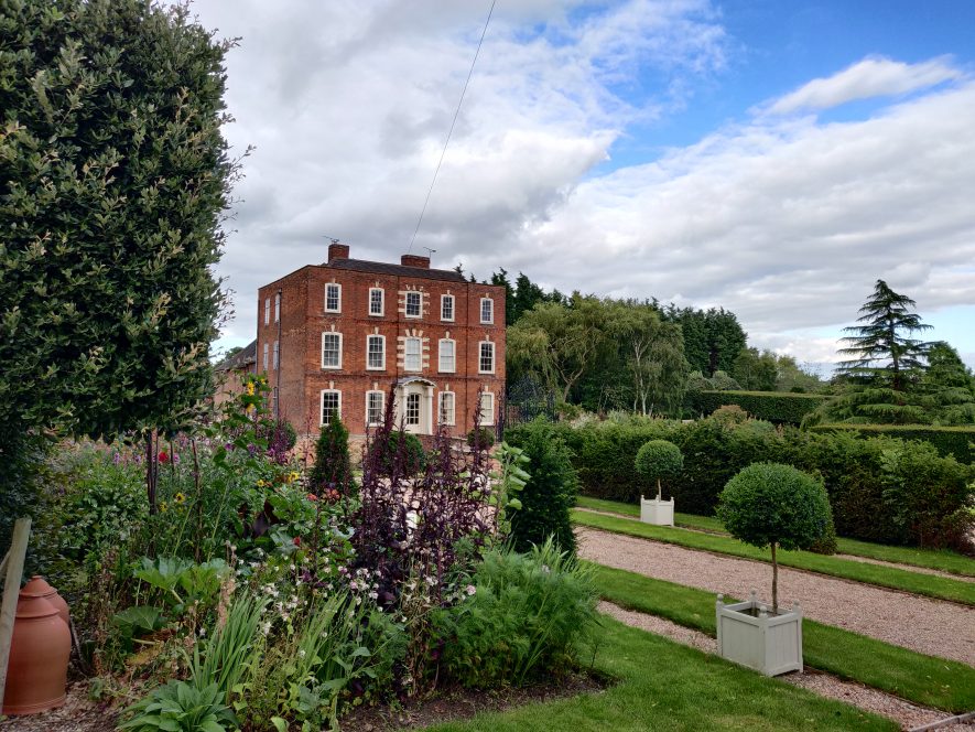 three storey red brick mansion set in formal gardens | Image courtesy of Matt Woolner July 2020