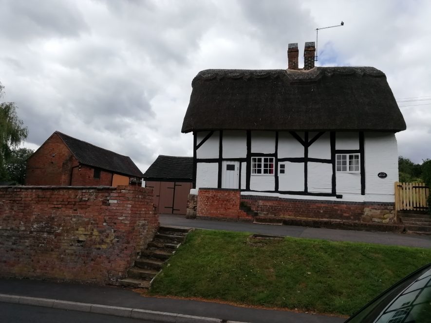 Two storey detached black and white medieval vicarage with thatched roof | Image courtesy of Gary Stocker, July 2020
