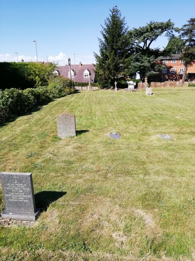 Churchyard with one or two graves in the photo, well spaced out. Houses in the rearground and a yew tree. | Image courtesy of Gary Stocker August 2020