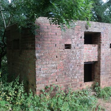 World War Two red brick pillbox, with overhanging trees | Image courtesy of Gary Stocker, 2020