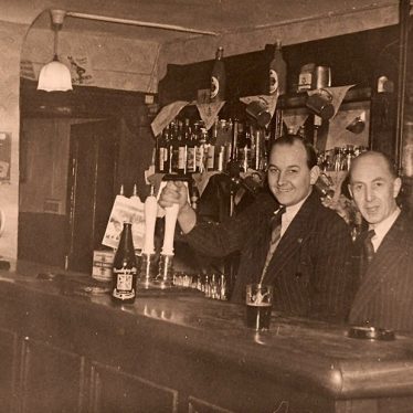 The public bar in the Old Bowling Green. The landlord Mr George Guinness (right) and his son in law Mr Thomas Goode Pratt. c.1953 | The Old Bowling Green Hotel. Rear view of the bowling green, c.1953