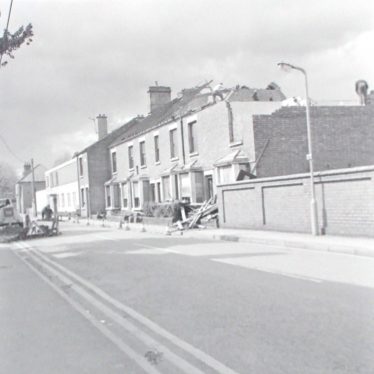 Photograph of Dugdale Street, Nuneaton looking towards Riversley Road, and showing houses in course of demolition. 1975. | Warwickshire County Record Office reference PH882/6/5033