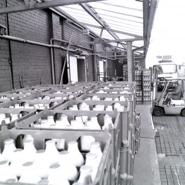 Loading bay showing crates of milk bottles ready to be loaded, at the Co-operative Society Dairy, Merevale Avenue, Nuneaton, 1990s. | Image courtesy of Nuneaton Memories