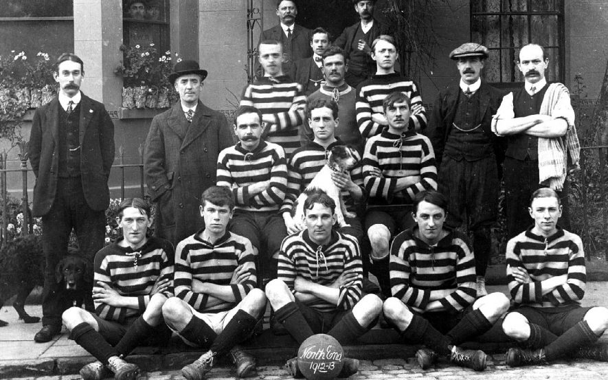 Leamington Spa Town football team group photograph. Players in sports kit, and some supporters. Football with words: 