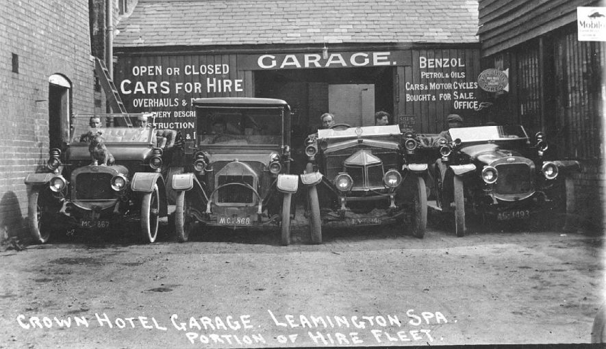 Crown Hotel garage showing four motor vehicles being part of the hire fleet.  1910s |  IMAGE LOCATION: (Warwickshire County Record Office)