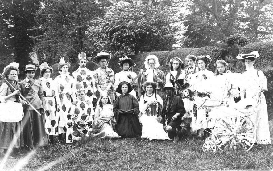 Group in fancy dress with decorated pram in the garden of the Abbey. Believed to be May Day, Southam. 1908 |  IMAGE LOCATION: (Warwickshire County Record Office) IMAGE DATE: (c.1908)