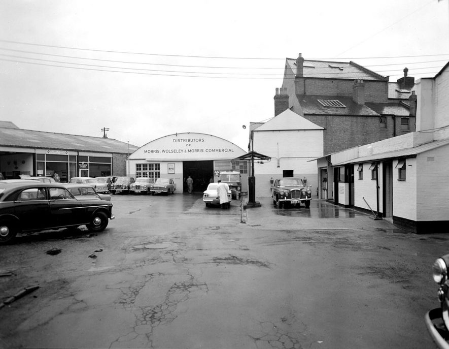 Motor cars and petrol pump with attendant on the forecourt of Regent Garage, Leamington Spa.  1962 |  IMAGE LOCATION: (Warwickshire County Record Office)