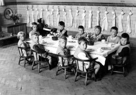 George Street Infants' School nursery class eating at table, Bedworth.  1930s |  IMAGE LOCATION: (Warwickshire County Record Office)