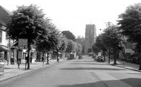 West Street with view of St James' church on top of West Gate, Warwick.  1950s |  IMAGE LOCATION: (Warwickshire County Record Office)