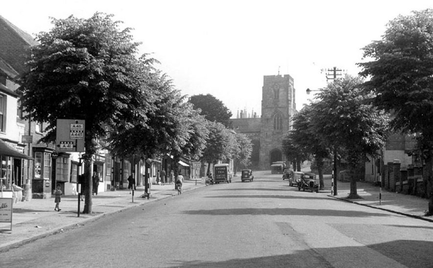 West Street with view of St James' church on top of West Gate, Warwick.  1950s |  IMAGE LOCATION: (Warwickshire County Record Office)