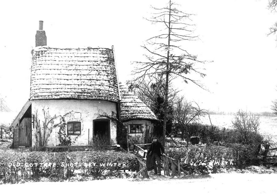 Small old thatched cottage in the snow at Shottery.  1900s |  IMAGE LOCATION: (Warwickshire County Record Office)