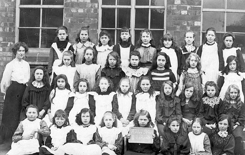 Group photograph of class of girls with female teacher, Nuneaton.  1900s |  IMAGE LOCATION: (Warwickshire County Record Office)