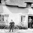 Moreton Morrell.  Man and boy with bicycle