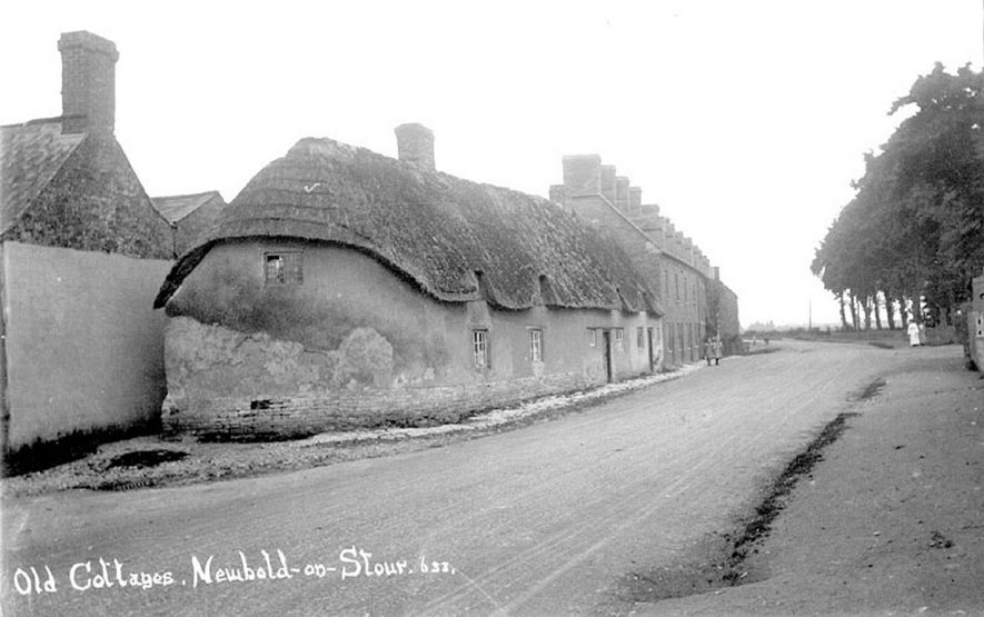 Picture of old cottages in Newbold on Stour.  Note the interesting shape of the nearest wall.  Photo taken prior to fire of March 6th 1919. See associated photos numbered PH  352/130/14 and PH 352/130/10 |  IMAGE LOCATION: (Warwickshire County Record Office)