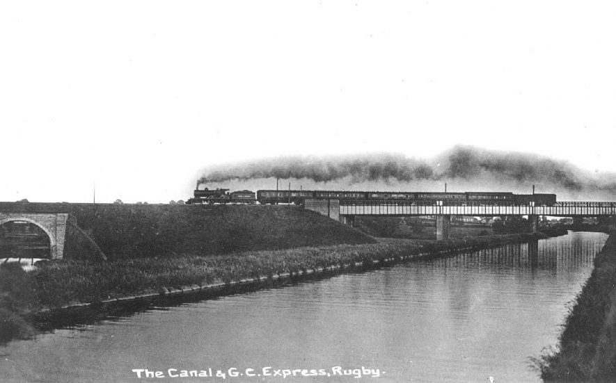 G.C. Express train with steam engine crossing railway bridge over canal, Rugby.  1910s |  IMAGE LOCATION: (Warwickshire County Record Office) SCAN DATE: (1/1198)