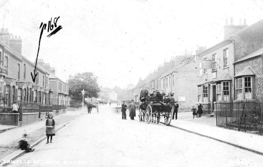 Terraced housing, children, horse-drawn vehicle with passengers, Lawford Road, New Bilton.  1900s
[It is thought that the house numbered 168 on the actual photograph is incorrect as that house is at the bottom of Lawford Road Hill and would be odd numbered. The front gardens are too big for houses at the cement works end of Lawford Road] |  IMAGE LOCATION: (Warwickshire County Record Office)