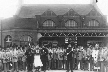 Rugby.  Band in fancy dress outside Railway Station