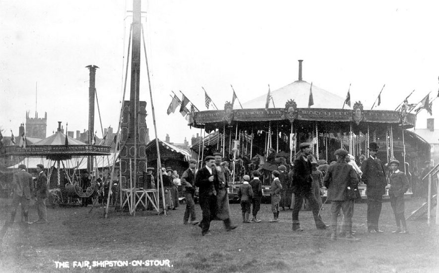 Fairground equipment and crowds at the fair. Shipston on Stour.  1900s |  IMAGE LOCATION: (Warwickshire County Record Office)