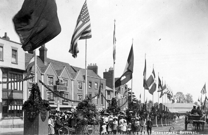 National flags in Bridge Street on Shakespeare Festival, Stratford upon Avon.  1900s |  IMAGE LOCATION: (Warwickshire County Record Office)
