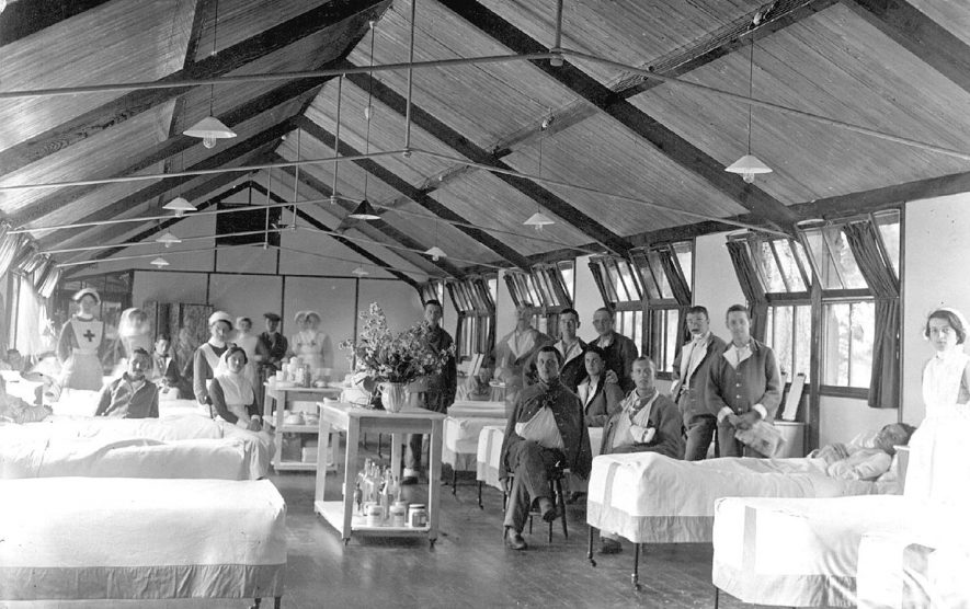 Interior view of a ward at Clopton House war hospital, Stratford upon Avon, with patients and staff also in picture.  1917 |  IMAGE LOCATION: (Warwickshire County Record Office)