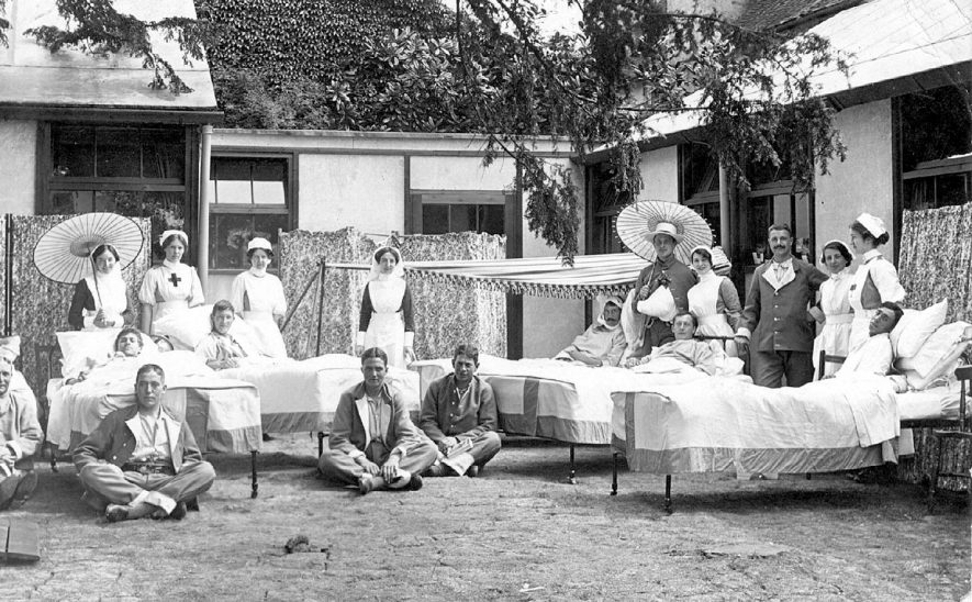 Staff and patients in their beds outside Clopton House war hospital, Stratford upon Avon.  1917 |  IMAGE LOCATION: (Warwickshire County Record Office)