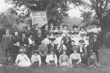 Warwick.  Group of men and women with religious banner