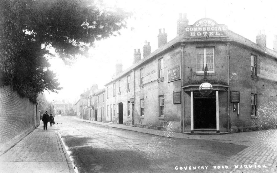 The Coventry Road, showing the Crown Hotel on the corner with Coten End, and the entrance to GWR station in the background.  1910s |  IMAGE LOCATION: (Warwickshire County Record Office)