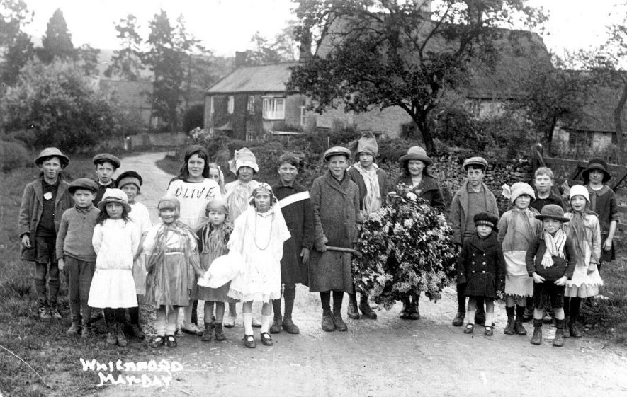 May Day in Whichford, featuring the May Queen with a group of villagers, one named Olive.  1920s |  IMAGE LOCATION: (Warwickshire County Record Office)