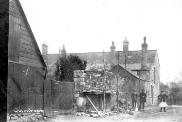 Whichford.  Workmen building a stone wall
