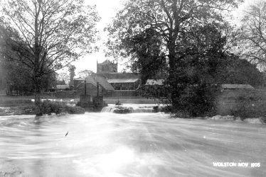 Wolston.  Floods in front of the Church