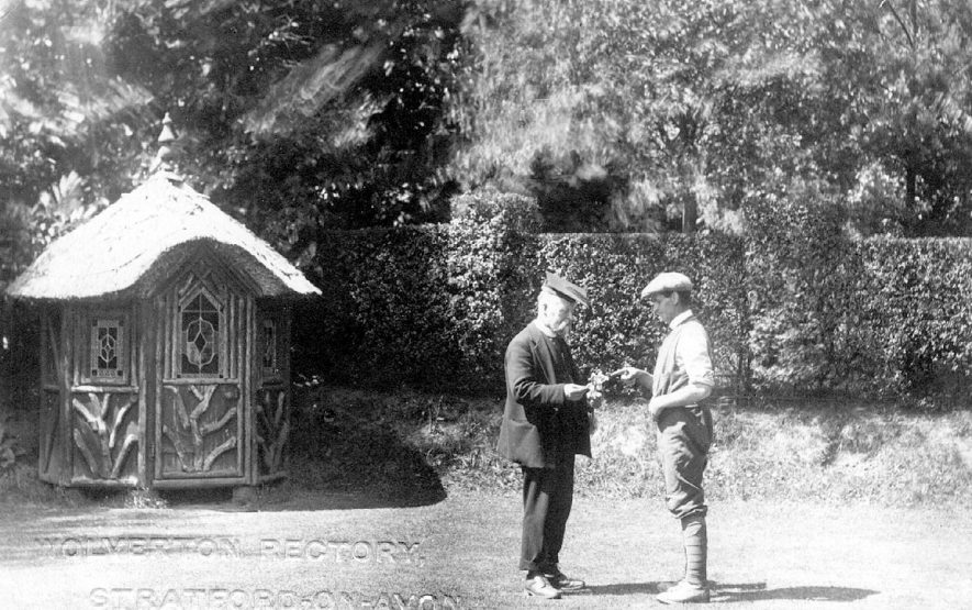 The Rector and his gardener in the Rectory garden, Wolverton, note the former is wearing a mortar-board on his head.  1900s |  IMAGE LOCATION: (Warwickshire County Record Office)