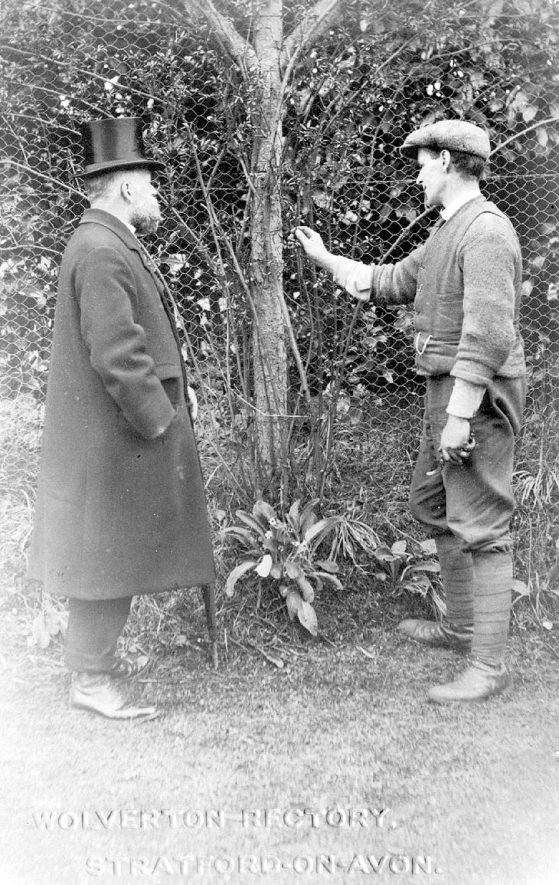 The Rector discusses gardening with his gardener, Wolverton.  1900s |  IMAGE LOCATION: (Warwickshire County Record Office)