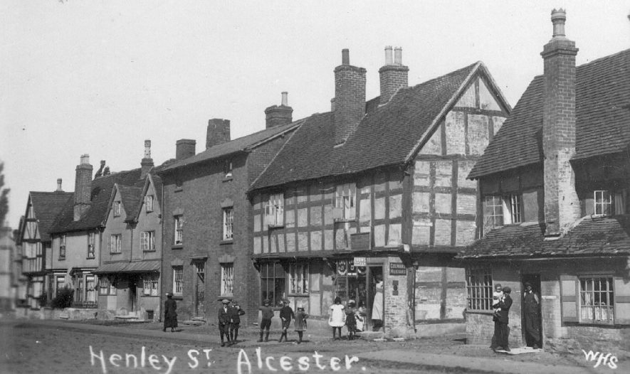 Henley Street, Alcester, showing houses, shops, people and children in the street.  1900s |  IMAGE LOCATION: (Warwickshire County Record Office)