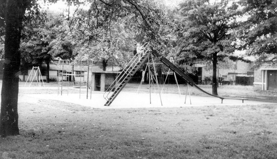 Swings, slide and climbing frame in the children's play area, Nuneaton recreation ground.  1960s |  IMAGE LOCATION: (Warwickshire County Record Office)