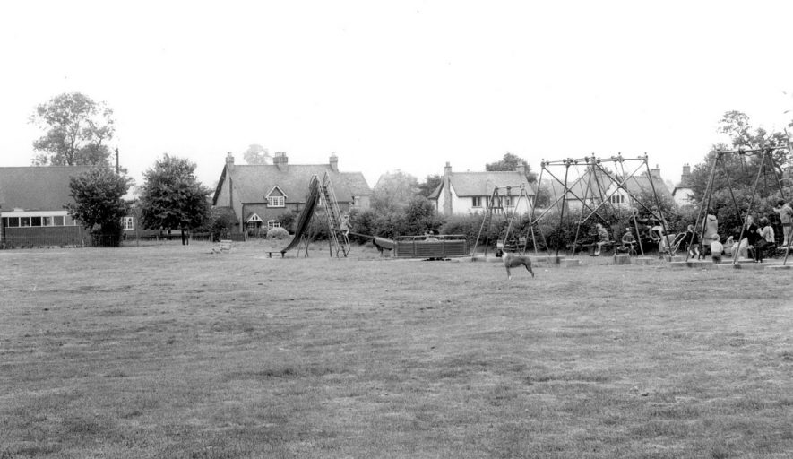 The Green, Water Orton, showing children at play on swings.  1960s |  IMAGE LOCATION: (Warwickshire County Record Office)