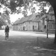 Monks Kirby.  Cyclist making his way through the village