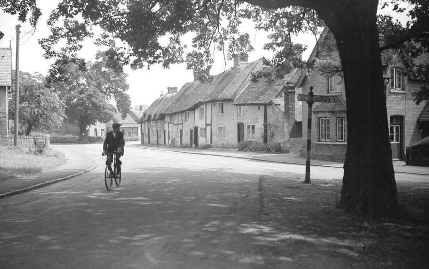 A solitary cyclist makes his way through the village of Monks Kirkby.  1951 |  IMAGE LOCATION: (Warwickshire County Record Office)