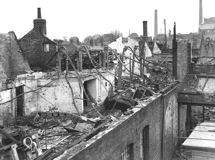 Bomb-damaged Midland Daily Tribune building, taken from Vicarage Street, Nuneaton.  Old mill (with chimney) right.  Courtauld's Tower (with clock) on skyline.  1940s |  IMAGE LOCATION: (Nuneaton Library)
