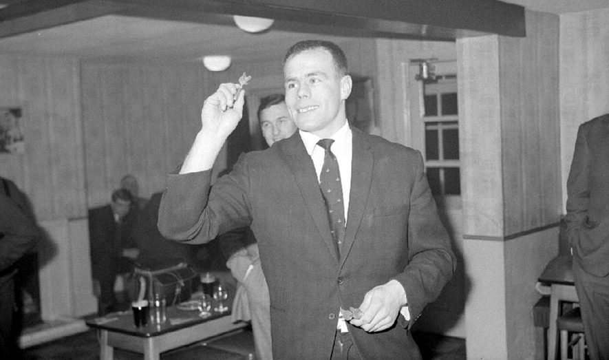 Coventry City F.C. players at a 'get together' at the 'Weavers Arms, Wood End, near Fillongley.  This is the City skipper, George Curtis, about to throw a dart.  1965 |  IMAGE LOCATION: (Warwickshire County Record Office) PEOPLE IN PHOTO: Curtis, George, Curtis as a surname