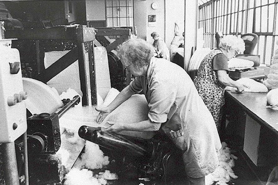 The Mill hatmaking workshop, Atherstone.  Pure sheep's wool is made into flat sheets and then into rough cone shapes.  1950s [ Identified as the Forming Shop.]  |  IMAGE LOCATION: (Warwickshire Museums. Photographic Collections.)