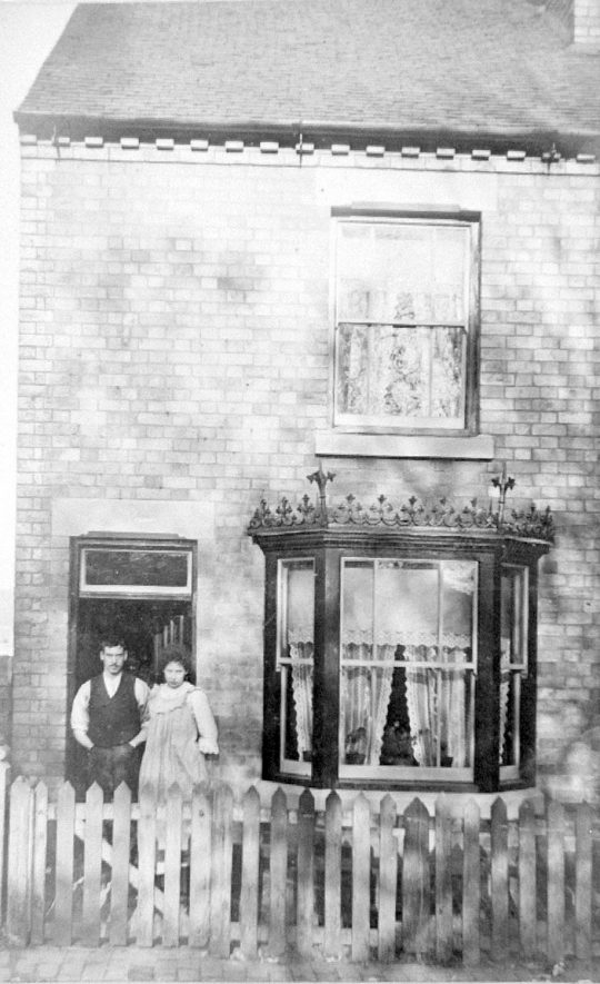 Man and woman at door of terraced house, Nuneaton.  1900s |  IMAGE LOCATION: (Warwickshire Museums. Photographic Collections.)