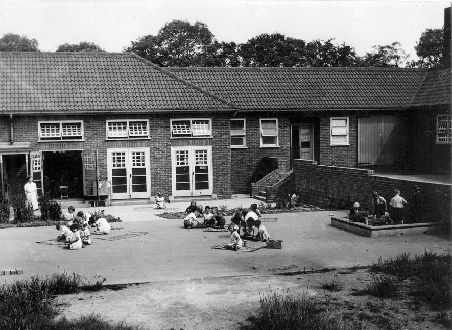 Group of children playing outside Hartshill Infants school.  1941 |  IMAGE LOCATION: (Warwickshire County Record Office)