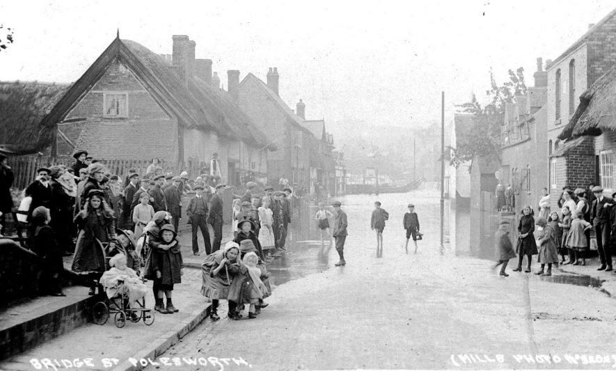 Large group of children looking at flooding in Bridge Street, Polesworth.  1910s |  IMAGE LOCATION: (Warwickshire County Record Office)